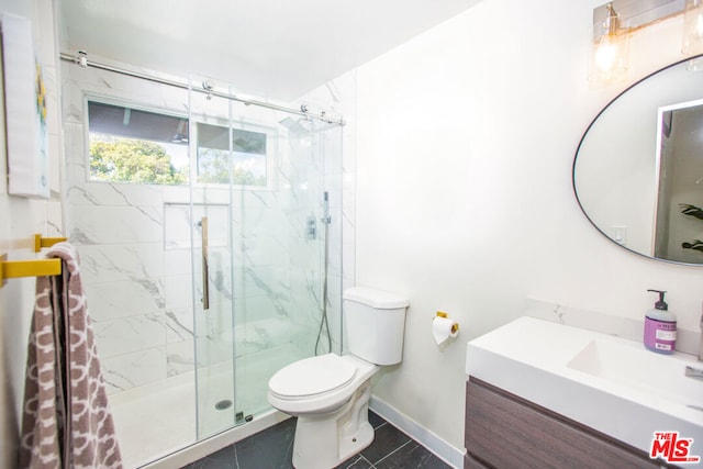 bathroom with tile patterned floors, vanity, toilet, and a shower with shower door