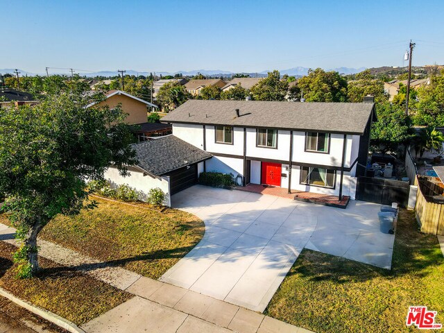 tudor house featuring a front yard and a garage