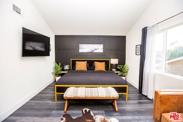 bedroom with dark hardwood / wood-style flooring and vaulted ceiling