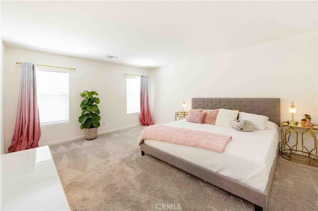 bedroom featuring light carpet