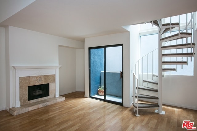 unfurnished living room featuring a fireplace and light hardwood / wood-style flooring