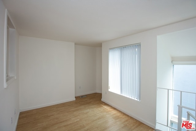 unfurnished room with light hardwood / wood-style floors