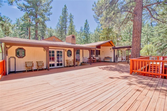 deck with an outdoor living space and french doors