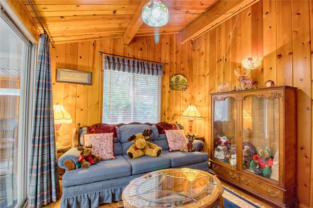 living room with vaulted ceiling with beams, wood ceiling, and wooden walls