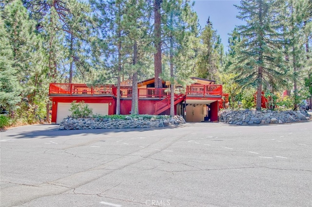 view of front of property with a garage and a deck