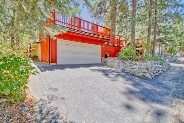 view of front of home featuring a garage and a deck