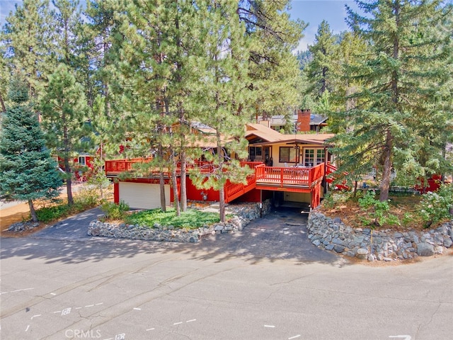 view of front of property featuring a garage and a deck