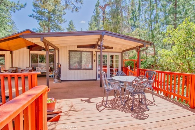 deck featuring outdoor lounge area and ceiling fan