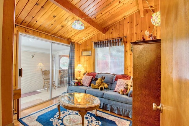 living room featuring vaulted ceiling with beams, wood ceiling, wooden walls, and hardwood / wood-style floors