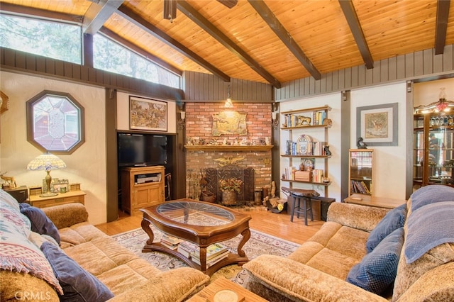 living room with lofted ceiling with beams, wooden ceiling, a fireplace, and light hardwood / wood-style flooring