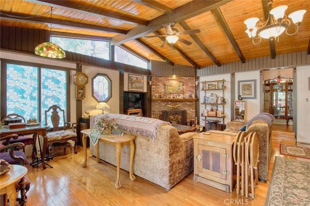 living room with wood ceiling, lofted ceiling with beams, a brick fireplace, light hardwood / wood-style floors, and ceiling fan with notable chandelier