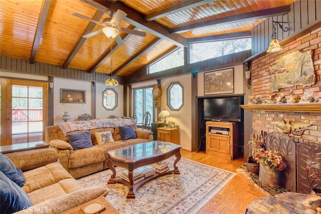 living room featuring wooden ceiling, a fireplace, lofted ceiling with beams, and light wood-type flooring