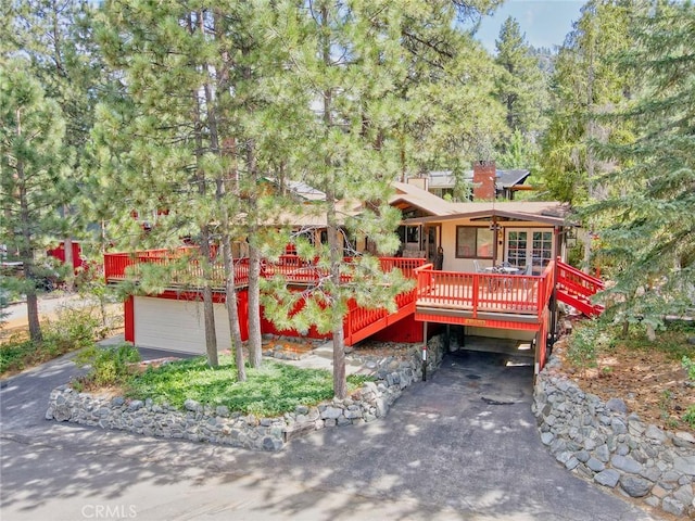 view of front of house with a garage and a wooden deck