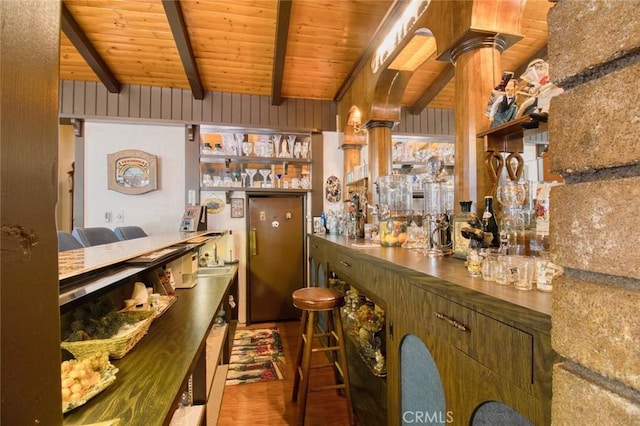 bar with hardwood / wood-style flooring, wooden ceiling, and beamed ceiling