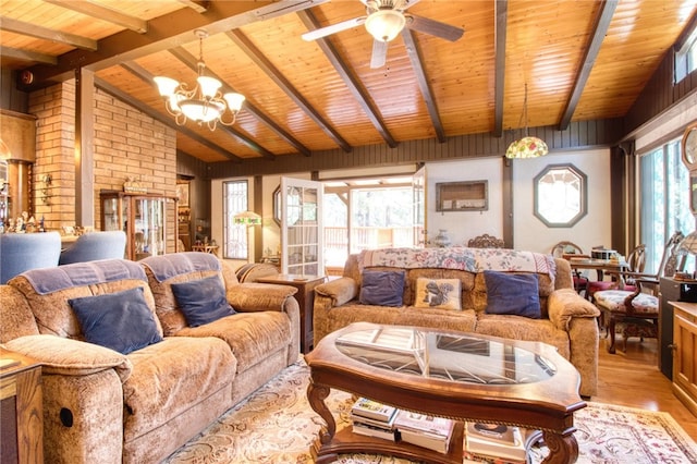 living room featuring vaulted ceiling with beams, ceiling fan with notable chandelier, wooden ceiling, and light wood-type flooring