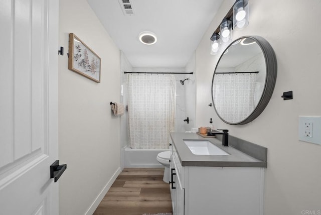 full bathroom with shower / bath combination with curtain, vanity, hardwood / wood-style flooring, and toilet