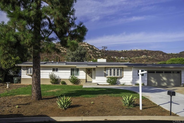 ranch-style house with a front yard and a garage