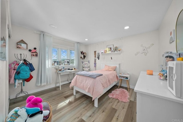 bedroom with light hardwood / wood-style floors