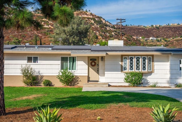 ranch-style home with a front lawn