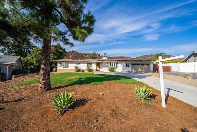 ranch-style home featuring a garage and a front yard