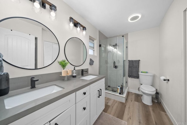 bathroom featuring vanity, hardwood / wood-style flooring, toilet, and walk in shower