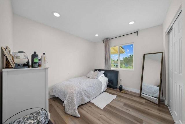 bedroom with a closet and light hardwood / wood-style floors