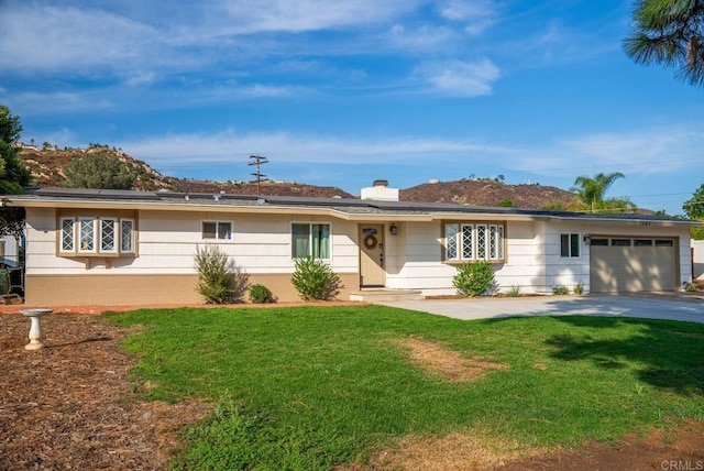 single story home featuring a front yard and a garage