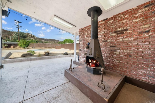 view of patio with a swimming pool and an outdoor fireplace