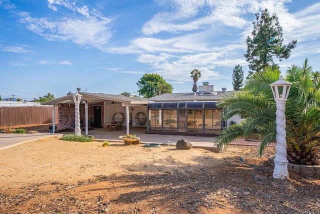 rear view of house with a sunroom and a patio area