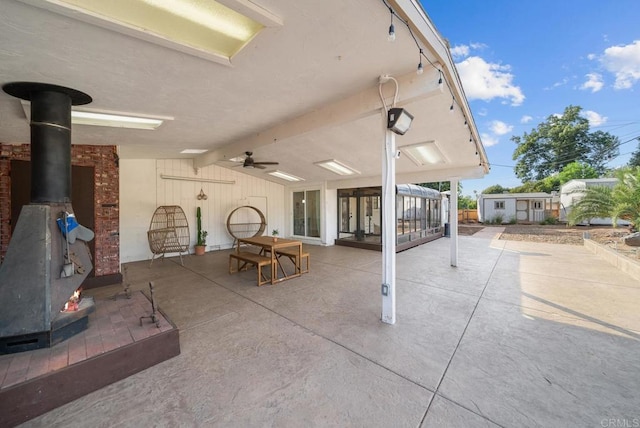 view of patio / terrace with a sunroom and ceiling fan