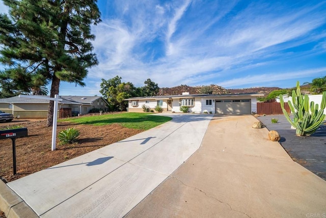 ranch-style house featuring a garage and a front yard