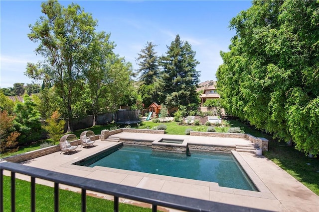 view of swimming pool featuring an in ground hot tub and a patio