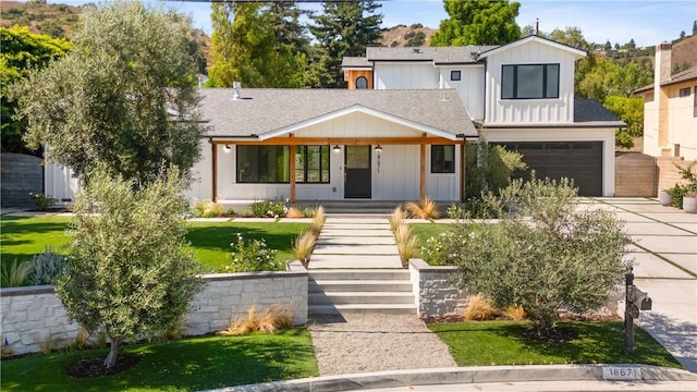 view of front facade featuring a garage and covered porch