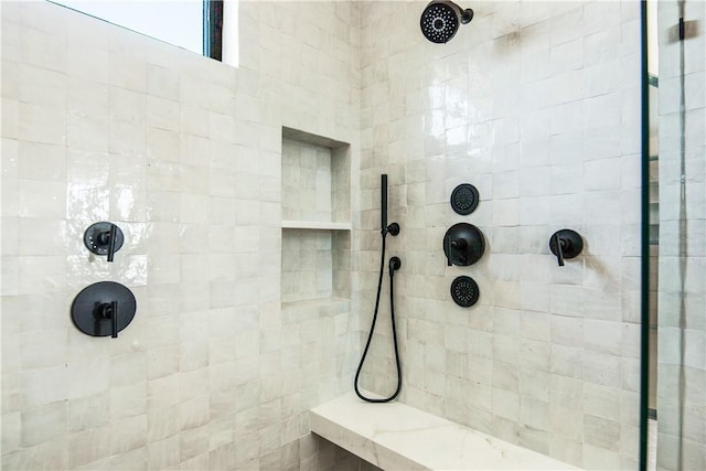 bathroom with tiled shower