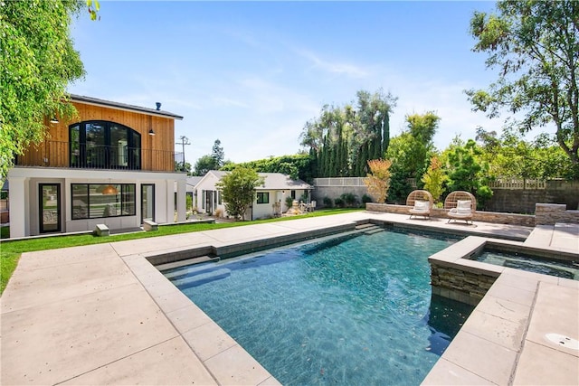 view of swimming pool featuring an in ground hot tub and a patio