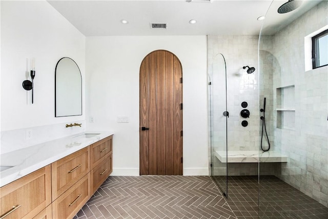 bathroom with vanity and a shower with shower door