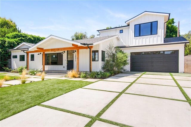 modern inspired farmhouse with a garage and a front yard