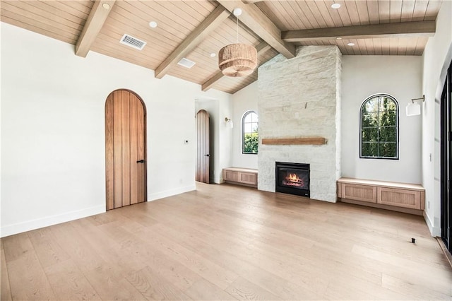 unfurnished living room featuring plenty of natural light, light hardwood / wood-style floors, and wooden ceiling