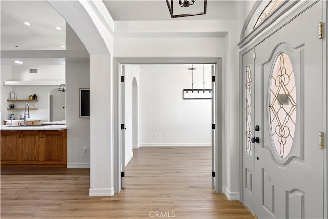 entrance foyer featuring light wood-type flooring and sink