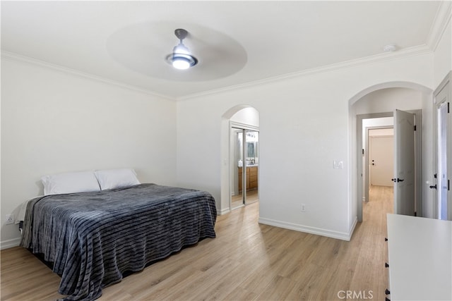 bedroom featuring ceiling fan, light wood-type flooring, connected bathroom, and ornamental molding