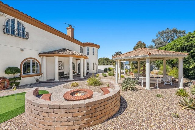 view of patio / terrace with a gazebo and a fire pit