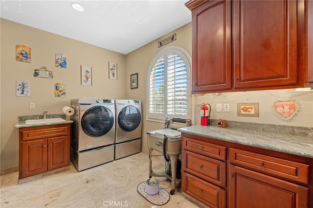 clothes washing area featuring cabinets, independent washer and dryer, and sink