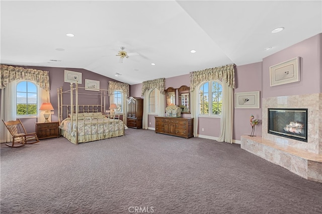 unfurnished bedroom featuring lofted ceiling, a high end fireplace, carpet, and ceiling fan