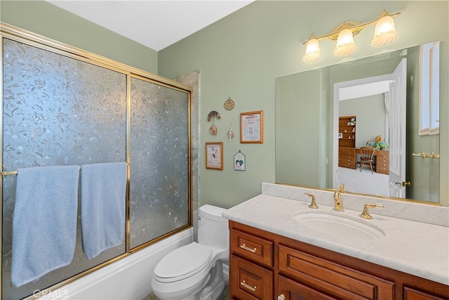 full bathroom featuring vanity, enclosed tub / shower combo, and toilet