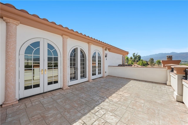 view of patio featuring french doors and a mountain view