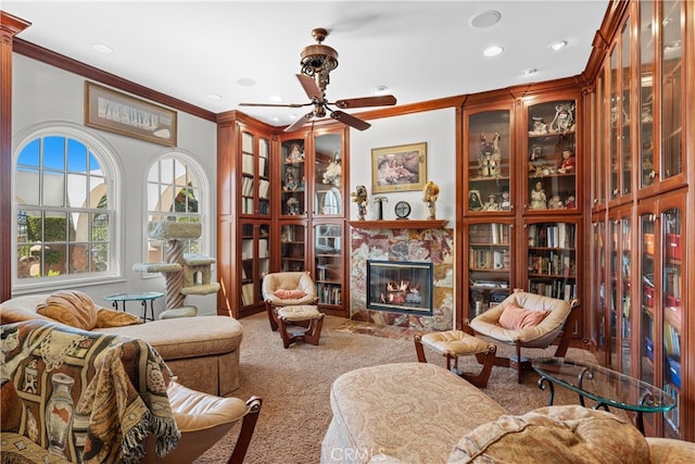 living room featuring ceiling fan, carpet flooring, ornamental molding, and a high end fireplace