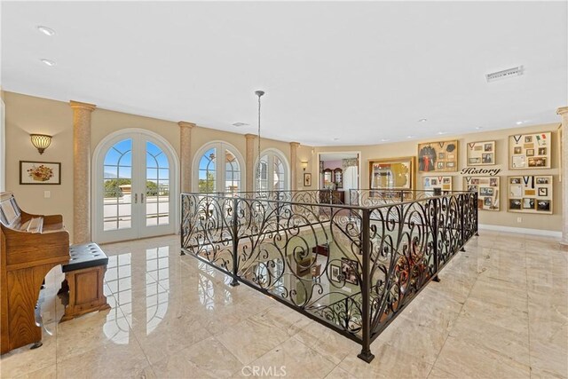 corridor with french doors and ornate columns