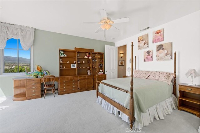 bedroom with ceiling fan, a mountain view, and carpet floors