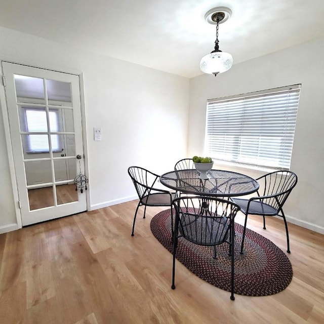 dining space with light wood-type flooring and a wealth of natural light