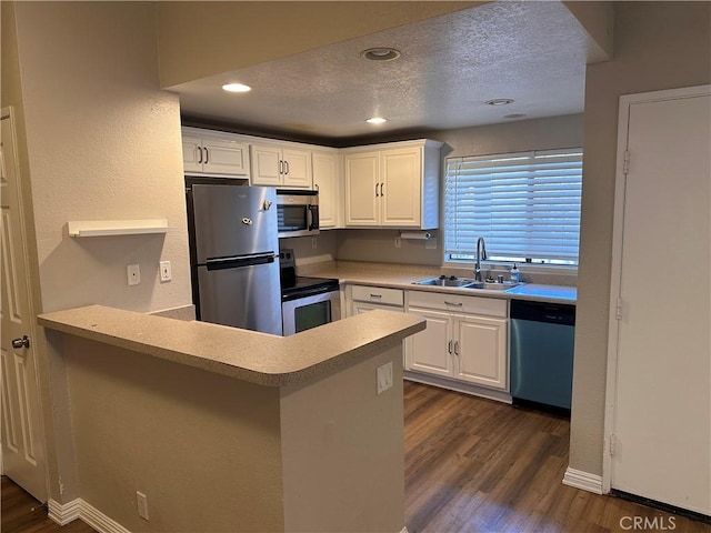 kitchen featuring sink, a textured ceiling, white cabinets, and appliances with stainless steel finishes